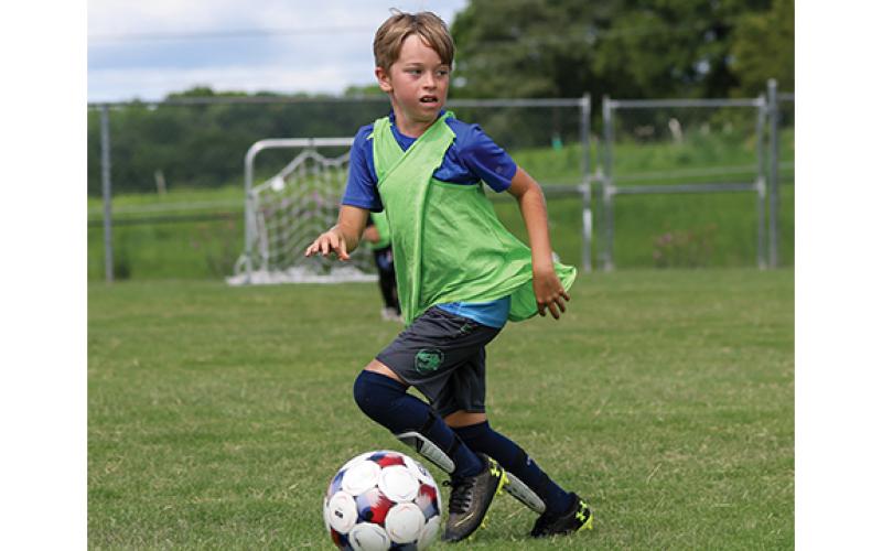 Raider soccer camper James Keane dribbles the ball during the Raider Soccer Academy Camp at Habersham Ninth Grade Academy on Friday, June 19. (Landen Todd/Staff)
