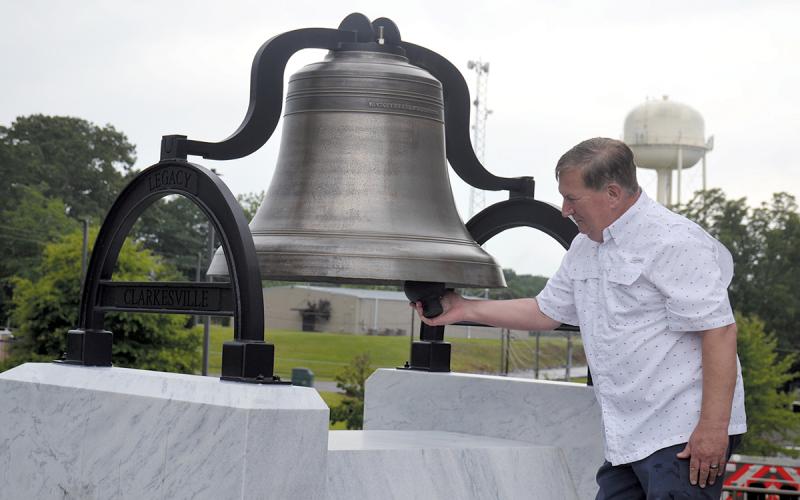 Commission Chairman Bruce Harkness was surprised with the opportunity to ring the old courthouse bell after its unveiling. Plans are to set the mechanism so the bell can not be rung and damaged. (Samantha Sinclair/Staff)