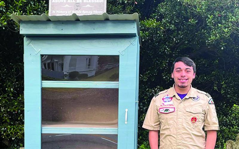 Eagle Scout Adam Moore poses at the food donation box he rebuilt at Clarkesville First Methodist Church for his Eagle Scout project. (Submitted)