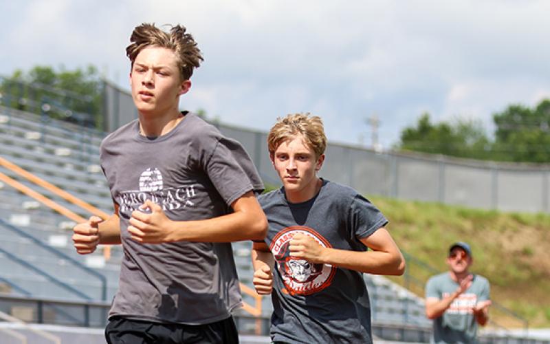 Habersham Central harriers Jadyn Recor and Peter Grieving in action during the cross country practice at Raider Stadium on Thursday, Aug. 6. (Landen Todd/Staff)