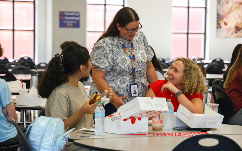 CTAE Director Dora Lucas (middle) shares a laugh with seniors Alexa Gasca (left) and Kamdyn Vandergriff (right) at the inaugural Chick-fil-A Leader Academy meeting on Wednesday. (Hannah Caudell/Staff)