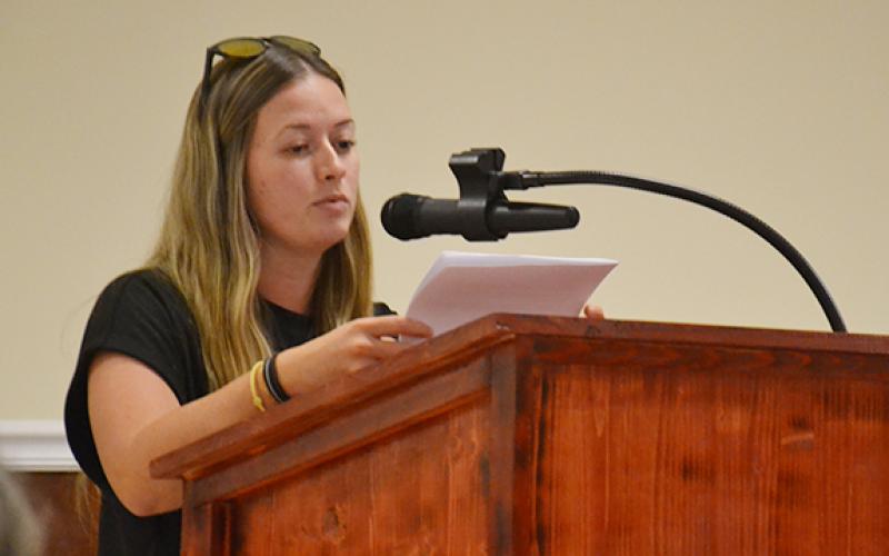Sydney Blackburn shares her concerns about the rezoning of 45 acres from the county's Suburban Residential to Baldwin's Highway Business during a second public hearing on Cook Construction's request Tuesday night. (Samantha Sinclair/Staff)