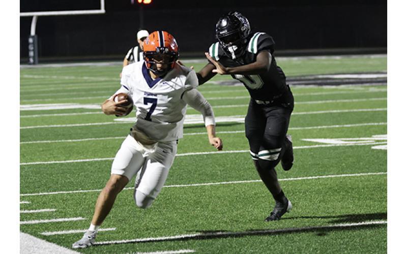 Habersham Central senior quarterback Paris Wilbanks (7) runs the ball against the Warriors on the road tonight. (Landen Todd/Staff)