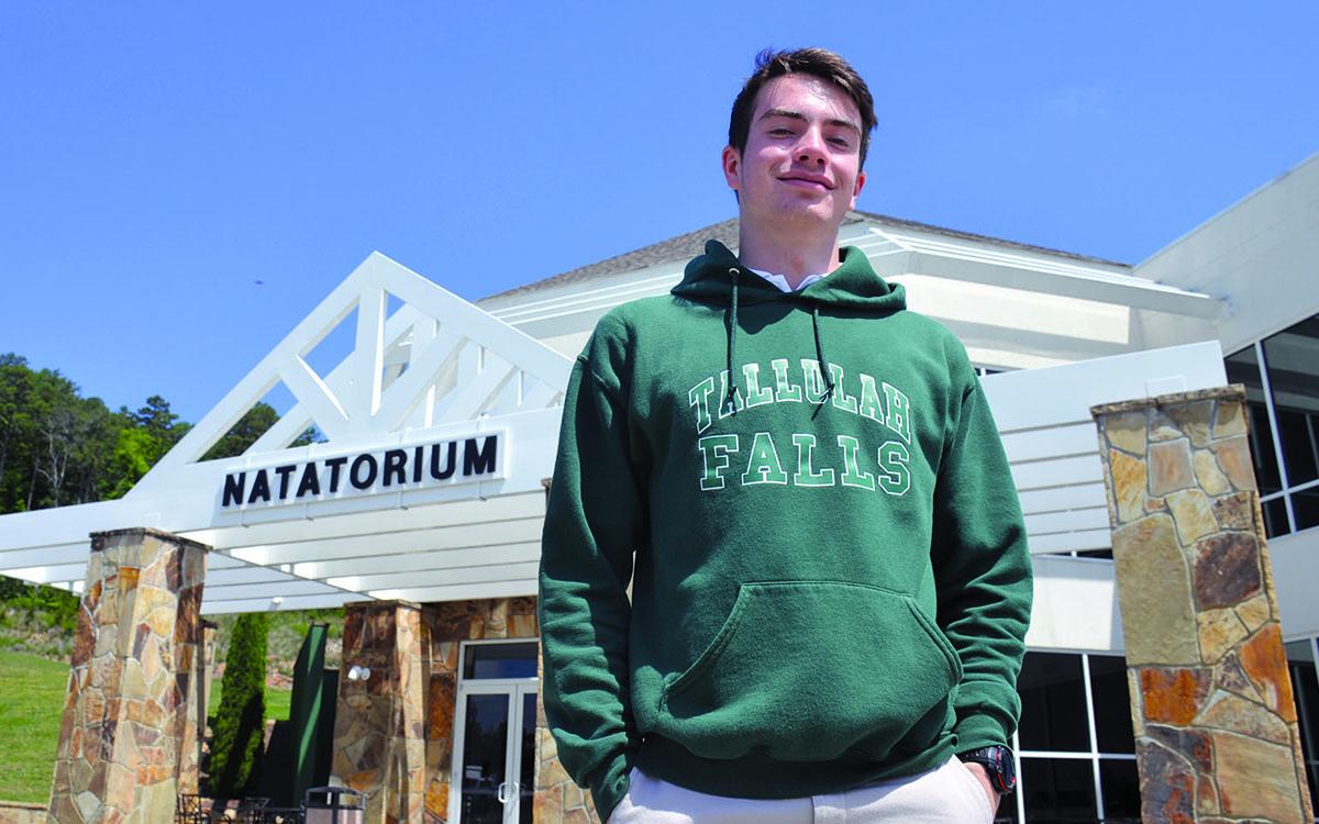 Caden Polley stands outside his home away from home, the TFS Natatorium.