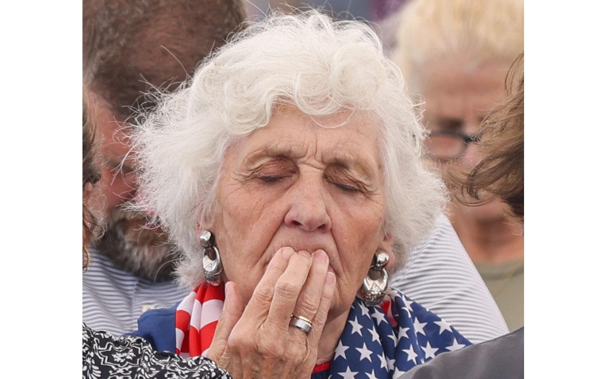 Myrna Fouts places her fingertips on her lips as she prays during National Day of Prayer at Donald Anderson Park in Cornelia on Thursday. (Landen Todd/Staff)