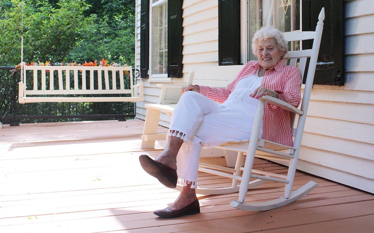 Mary Louise Berghal sits on the front porch of Acoa, an old plantation house in Habersham County that was built in 1834. (Hannah Caudell/Staff)