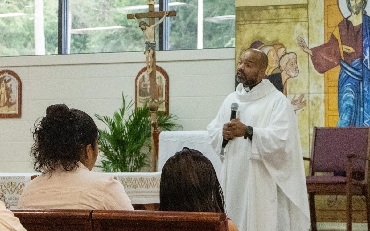 Father Jose Raul DeLeon shares a message with worshippers on Saturday during the evening Mass at St. Dominic Chapel, where worshippers often fill the chapel and spill into the hallway to hear a weekly message spoken in Spanish. (Hannah Caudell/Staff)