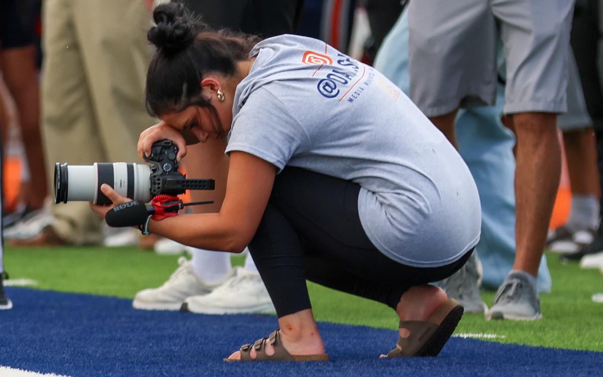 Habersham Central High School senior Oaklee Jackson tries to get a different angle for a photo during a Raider Football game. (Landen Todd/Staff)