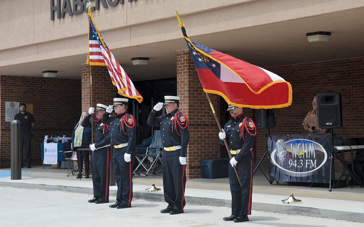 Jamie Tyler, Shawn McClure, Randi Seabolt and Kyle Shelton of the Last Call Honor Guard present the colors for the Pledge of Allegiance at the Shop with a Hero Benefit Car Show in May. (Samantha Sinclair/Staff)