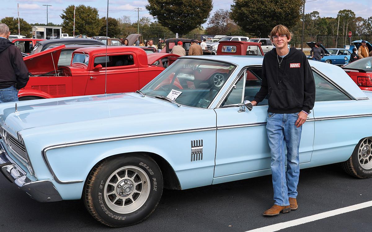 Clarkesville native Zac Bonner poses with his 1966 Plymouth Fury III during the L3R Memorial Foundation car show at Habersham Central High School on Saturday, Oct. 24. Bonner was a top-ten winner. (Landen Todd/Staff)