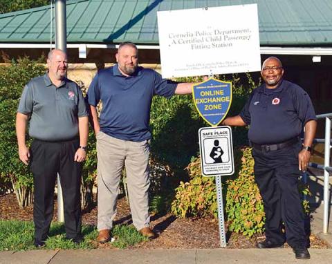 Shown with one of the new “safe haven” signs, located at the Cornelia Police Department, is, from left, City Manager Donald Anderson, Police Chief Chad Smith and Fire Chief Billy Jenkins Jr. (Photo/CHRISTINA SANTEE)