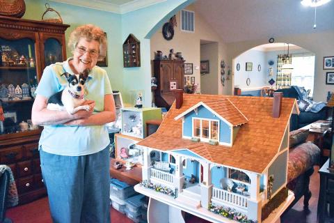 Joan Salute has been working with miniatures for about 35 years. She has 20-25 room boxes and a dollhouse displayed throughout her house, each one with a different theme. Salute holds her 8-year-old chihuahua named Heidi. (Photo/CHAMIAN CRUZ)