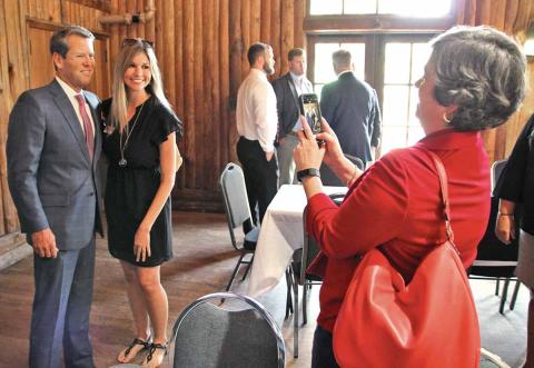 Gov. Brian Kemp and Habersham Chamber of Commerce President Mary Beth Horton get their picture taken by Chamber Administrative Assistant Kristy Hammond. (Photo/ERIC PEREIRA)