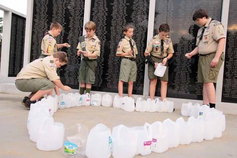 Boy Scouts Troop 106 of Homer and Troop 5 of Clarkesville help with the candlelight vigil at the Habersham County Veterans Wall of Honor, Cornelia. The ceremony paid respects to the victims of the 9/11 terrorist attacks. Shown, from left, are Samuel Hattaway, Matthew Owens, Caleb Crump, Mitchell McGahee, Joseph McGahee and Cameron Mote. (Photo/ERIC PEREIRA)