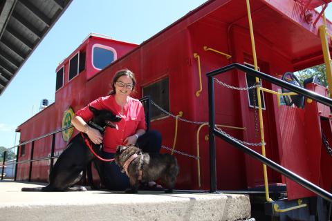 Eric Pereira/ Cornelia Tourism Coordinator Brittain Williams and her dogs Cerin and Tara are shown at the Cornelia Depot. Visitors are allowed to bring their dogs into the Cornelia Historic Train Depot and Museum.