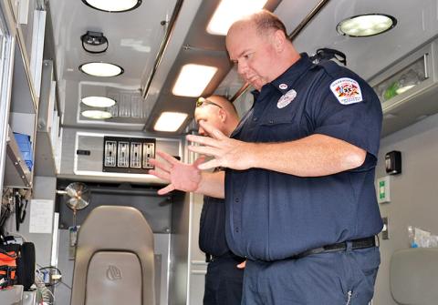 Paramedics Greg Ramey, right, and Cody Crocker talk Friday about some advances Habersham County has made over the years with its emergency medical strategies over the years. 