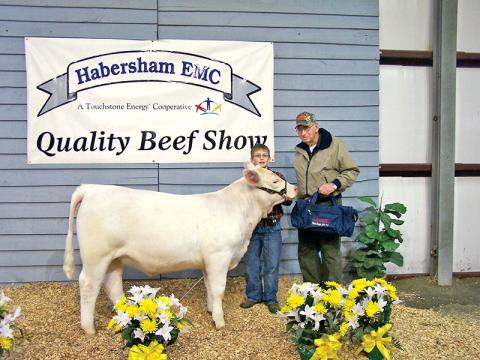 Barrett and one of his three grandchildren smile for a picture after the Habersham Electric Membership Corp. Quality Beef Show. Barrett was inducted into the 2019 Habersham County Farm Bureau Agriculture Hall of Fame Friday for his contributions to the agricultural community.