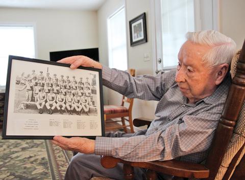 Donald Tench shows a photo from his Army days. Tench, 90, served 38 years in the Army and reserves. He continues to participate in military funerals which he has done for over 60 years. 