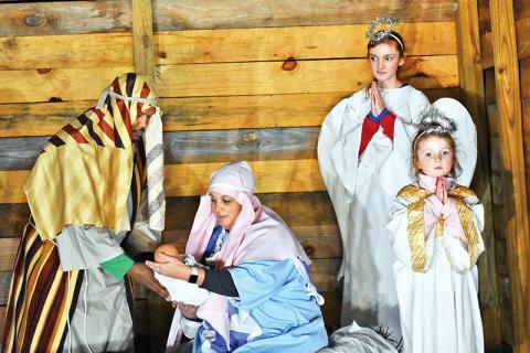 Left to right, are Tore Christiansen as Joseph and Monica Christiansen as Mary holding baby Jesus, while angels McLain Allen and Quinn Allen look on.