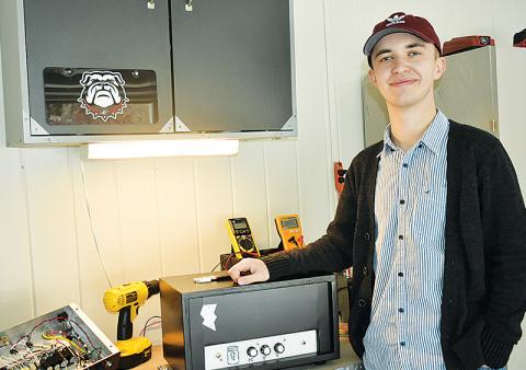 Maison Cloautre’s hobby of building boutique guitar amplifiers led him to have one of his own included at Capricorn Studios for musicians to use alongside those made by Fender and other big names. Clouatre poses for a photo while displaying the inside of his very first boutique guitar amplifier, which he continues to work on today.