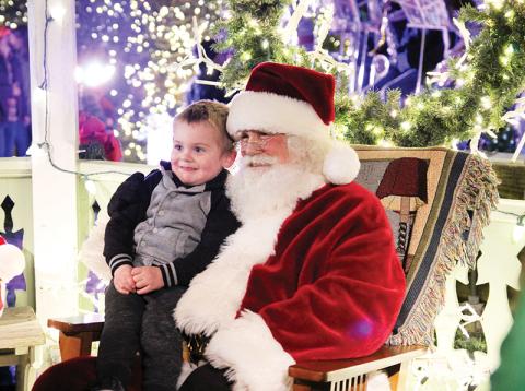 Jameson Baker, 3, of Clarkesville gets a photo with Saint Nick at A Downtown Clarkesville Christmas.