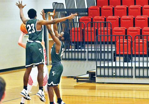 Rabun County’s Connor McKay is swarmed by Tallulah Falls defenders Devonte Allen (23) and Simeon Respress during Friday night’s game. The Indians turned the game around with a full-court press before falling late.