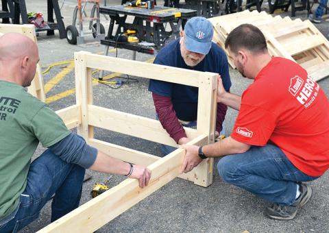 Volunteers Jason Grooms (left), Skip Sevier and Jeremy Gattis assemble the first of 20 bunk beds built Saturday by Lowe’s volunteers in conjunction with the charity Sleep in Heavenly Peace.