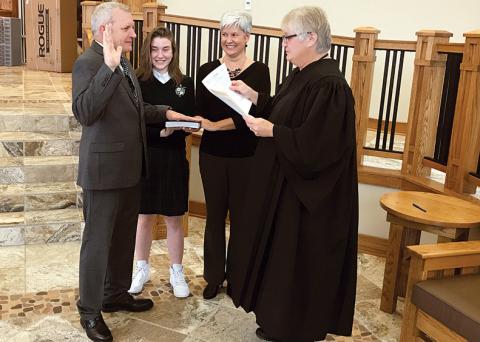 Newly elected District 5 Habersham County Commissioner Tim Stamey is sworn in Monday at Tallulah Falls School along with daughter Sam Stamey, wife Kerry Stamey and Habersham County Probate Judge Pam Wooley.