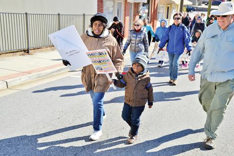 Vanessa Burns and Langston Mayfield walk in Sunday’s Dr. Martin Luther King Jr. Peace Walk in Cornelia. Mayfield represented a strong contingent of children who participated in the event.