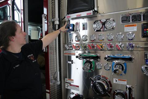 Cornelia firefighter Erin Higgins points out the foam gauge on the engine. Several local departments already use environmentally friendly foam.