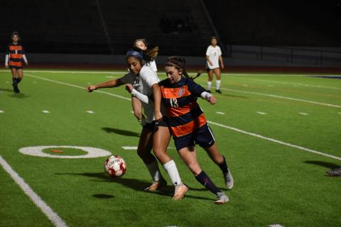 Habersham Central's Addie Penick fights for the ball with a Lanier High School defender Wednesday.