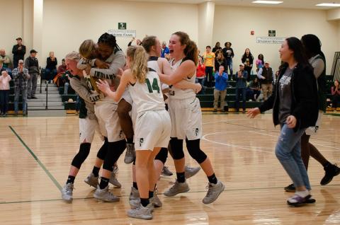 The Lady Indians celebrate after beating Paideia High School 51-50 in the first round of the Georgia High School Association state basketball tournament Friday.