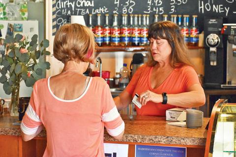 Angie Guthrie, owner of Java Joe’s Coffee Shop in Clarkesville, sells a gift card to Sheila Humphrey on Saturday. Photo by CODY ROGERS/Staff