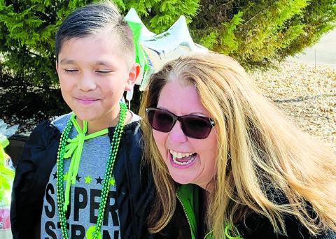 Level Grove Elementary School Principal Dr. Darlene Hudson stands with fourth grader Junior Gutierrez at his cancer-free diagnosis celebration.