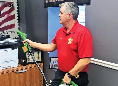 Chad Black, director of Emergency Services, demonstrates the Bioesque Botanical Disinfectant spray used to kill coronavirus on the person of EMTs and patients.