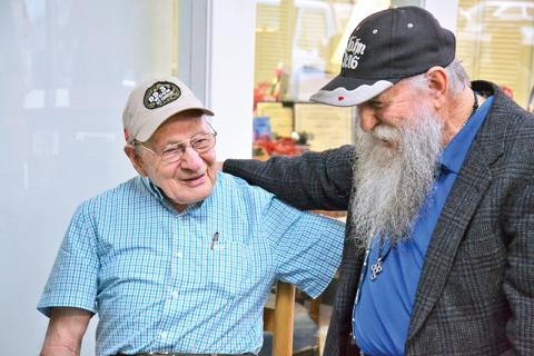 Billy Burrell (left) shares a laugh with John A. Harris at his birthday party on Friday morning.