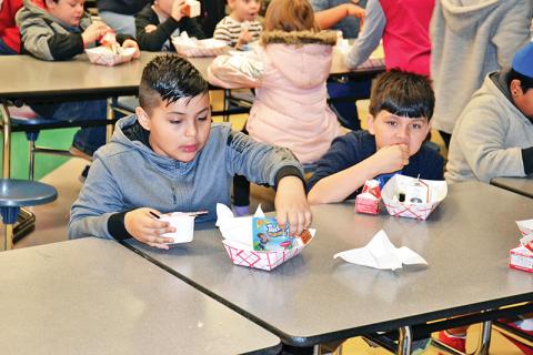 Level Grove Elementary students Christopher Negrete and Jonah Edmonds enjoy their breakfast Thursday morning before starting the school day. All students in Habersham County receive free breakfast before school in the morning.
