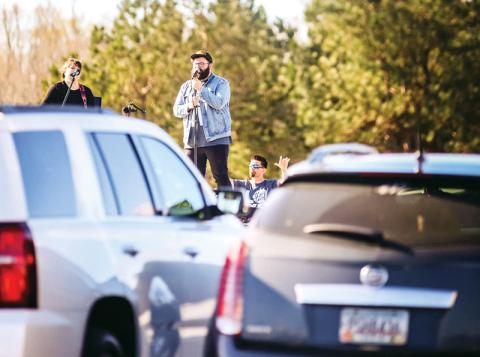 Eric and Misty Wilcox sing at The Torch’s drive-up prayer service Saturday to promote social distancing during this COVID-19 crisis. Photo courtesy of The Torch