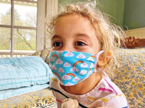 Ruby Benton poses with one of the homemade masks.