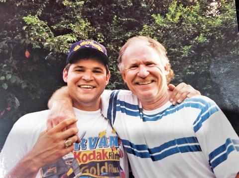 Judge James Butterworth, right, stands with his son, Jim Butterworth. Jim Butterworth said the world has lost “a lion” with the death of his father.