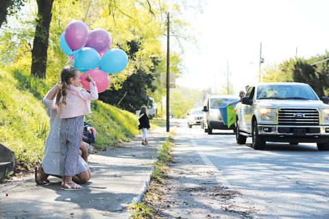 Ellie Jean Phillips and her mom Lizzy wave to friends and family at the birthday parade Friday in Clarkesville.