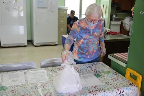 Habersham Soup Kitchen volunteer Geriann Jones prepares a plate to hand out during their lunch take out hours. The soup kitchen has distributed more than 600 meals since March 19. Photo by ERIC PEREIRA