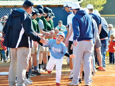 Easton Martin high-fives Tallulah Falls School and Habersham Central High School players during HCLL Opening Day in 2019.