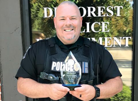 Former Demorest Police Chief Robin Krockum shows off the department’s award for best highway safety in the state in 2018-19.