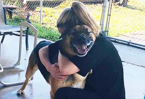 Animal Care and Control Director Madi Nix hugs Rudolph, who was recently adopted.