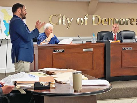 Cornelia Mayor John Borrow (left) makes a presentation Tuesday to the Demorest City Council, including Councilman Sean Moore (seated middle) and Mayor Rick Austin. Photo by ERIC PEREIRA