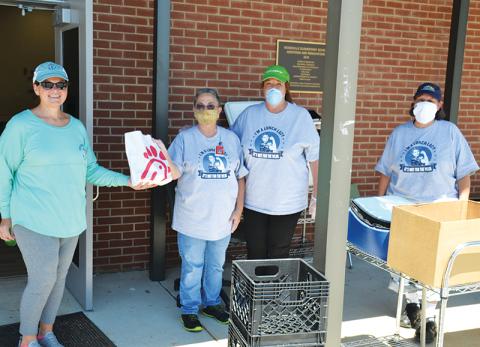 Stephanie Walker, transportation director for Habersham County Schools, delivers Chick-fil-A lunches to Woodville Elementary’s nutrition crew Friday including Jackie Cane, manager Liz Martin and Mary Beth Justice of the Ninth Grade Academy.