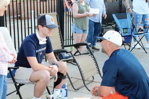 Hadden Carswell (left) talks with Habersham Central baseball coach Chris Akridge on Friday night at a community event celebrating his release from the hospital. 