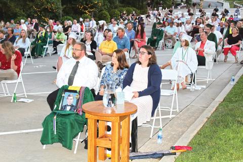 The family of Stephen Bowman – from left, father Matthew, mother Cherie and sister Sarah Black – listen to remarks at Friday’s graduation at Tallulah Falls School. Stephen graduated from the school this year, but passed away in a drowning accident June 13. 