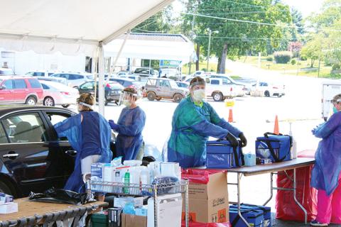 Healthcare workers test patients at a drive-thru COVID-19 event on June 13 in Cornelia. Photo by ISAIAH SMITH/staff